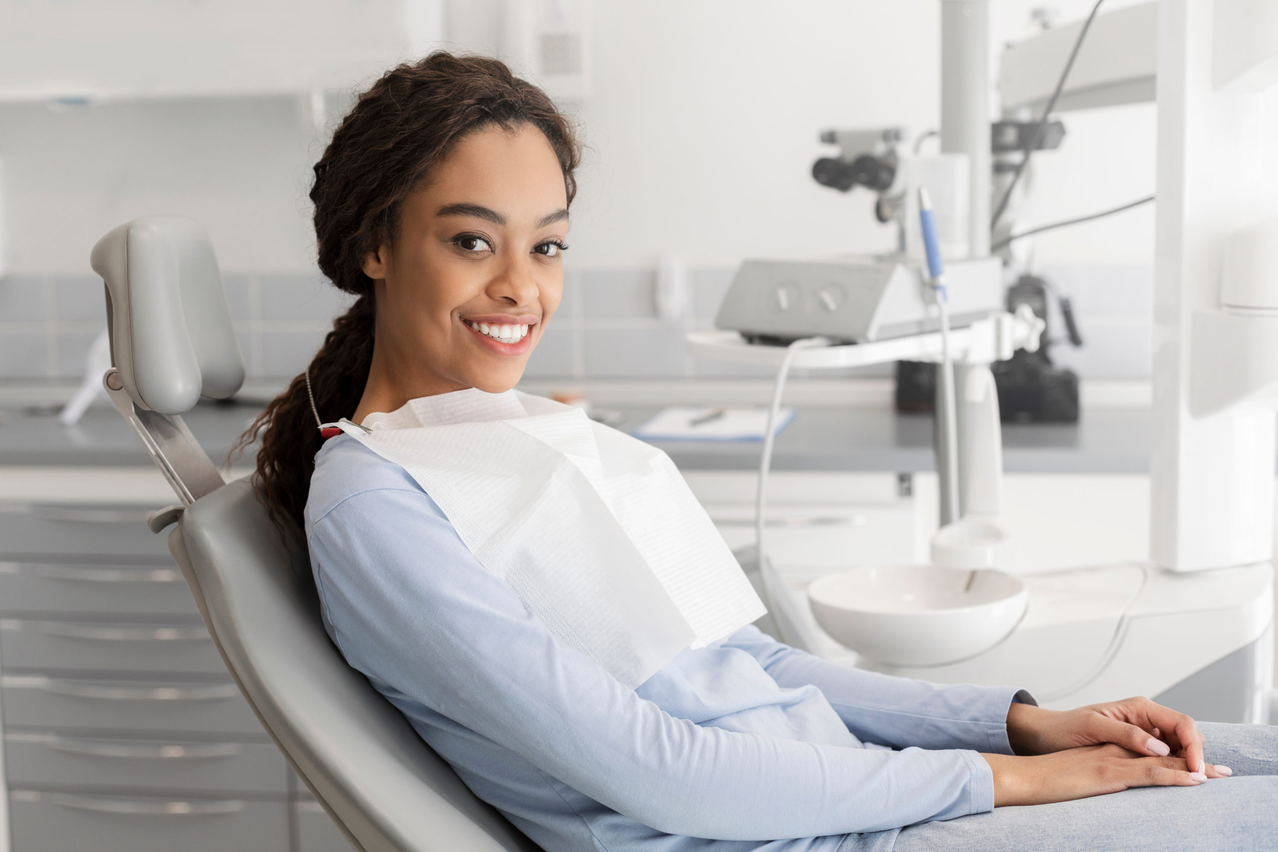 Young,Black,Lady,Sitting,In,Dentist,Chair,And,Smiling,At Choosing Dentist